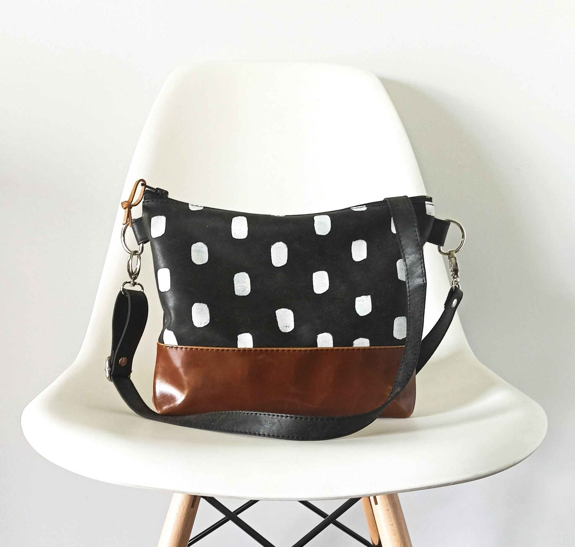 small crossbody bag in black and brown. 